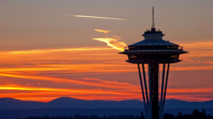 The Space Needle, a Seattle landmark, silhouetted against a colorful sunset